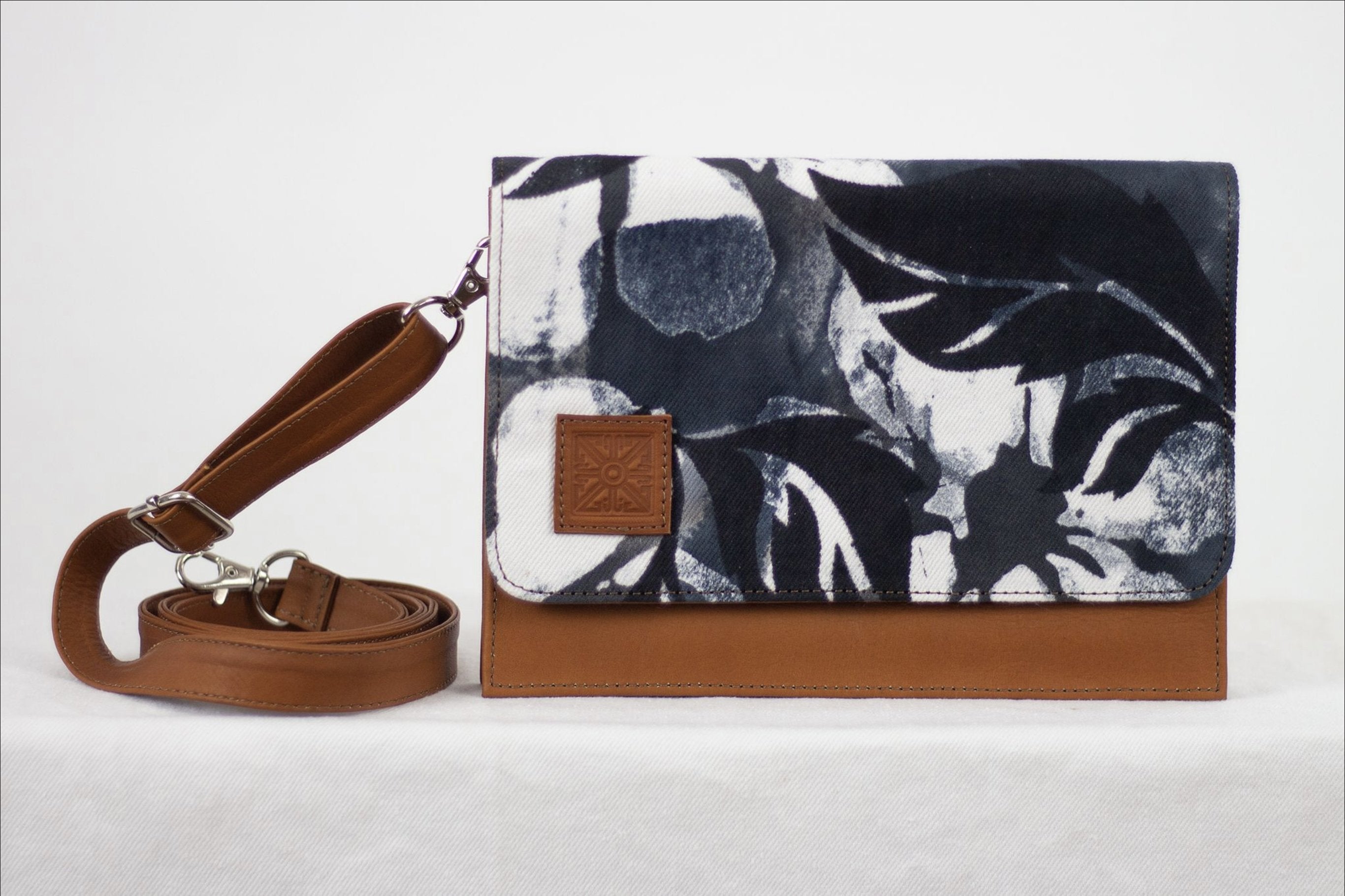 * Hand painted, leather trimmed cross body tote with the black and white “hula nights” pattern. #1