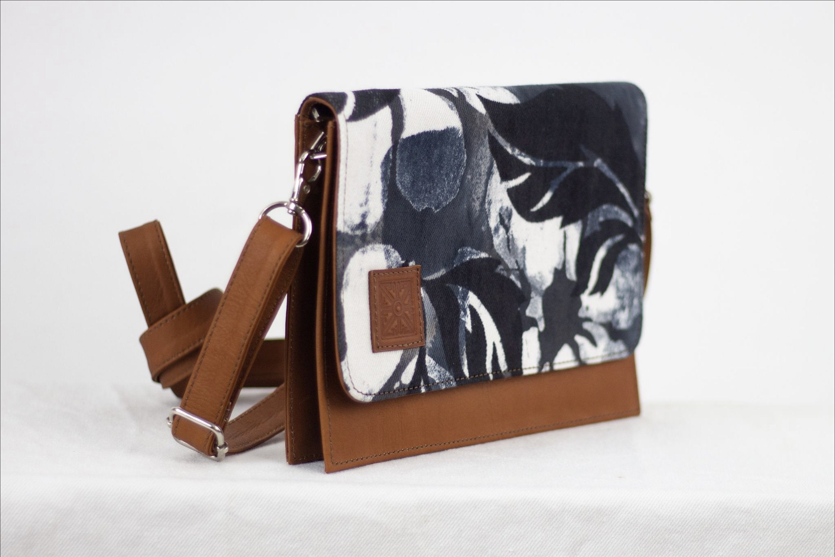 * Hand painted, leather trimmed cross body tote with the black and white “hula nights” pattern. #3