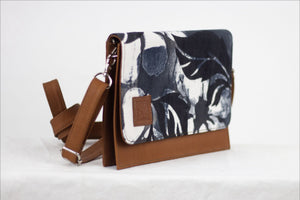    * Hand painted, leather trimmed cross body tote with the black and white “hula nights” pattern. #3